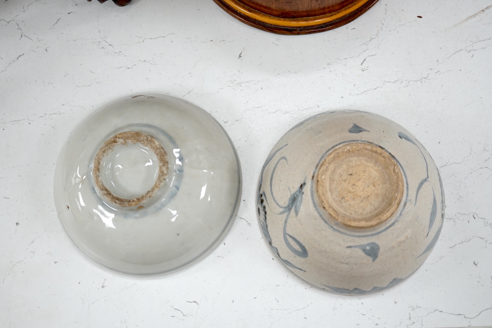 A Chinese blue and white plate, a tea bowl, two pottery bowls and a wooden stand (5). Condition - fair to good.